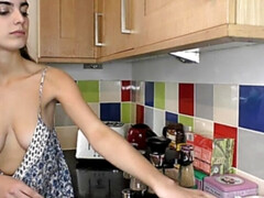 Hot brunette in the kitchen working and showing boobs